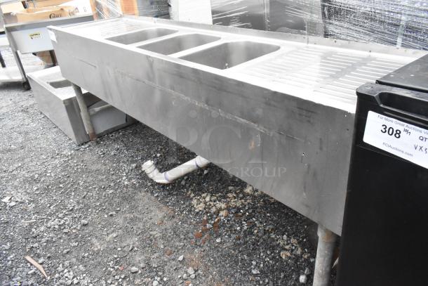 Stainless steel 3 bay back bar sink with dual drain boards, visible wear, auction tag 308, essential for commercial use.