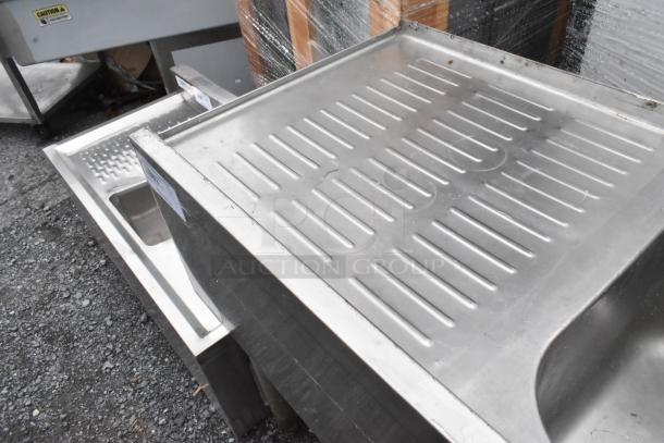 Stainless Steel 3 Bay Back Bar Sink with dual drain boards, minor surface scratches, solid construction, suitable for commercial use.