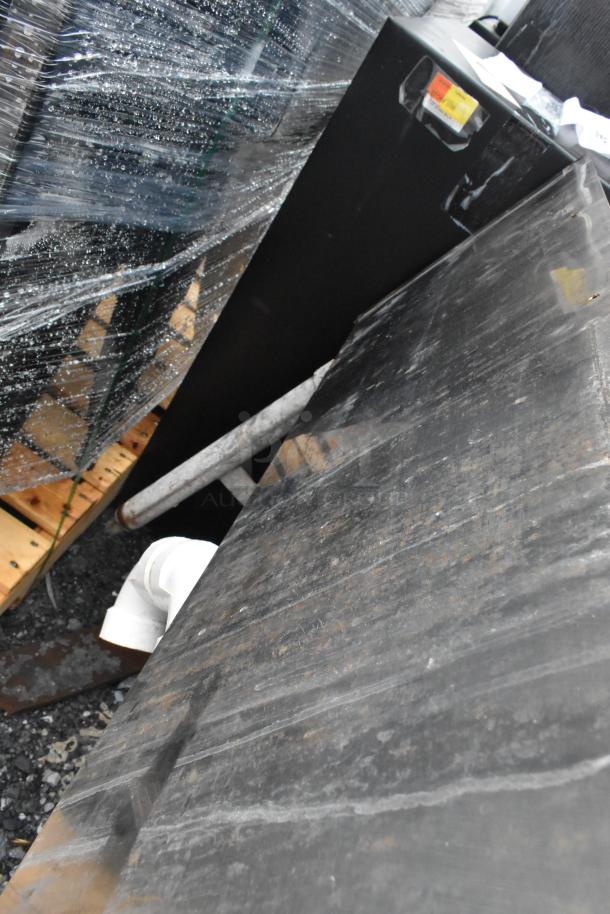 Stainless steel 3-bay back bar sink with dual drain boards, shown partially wrapped and outside, suggesting used condition.