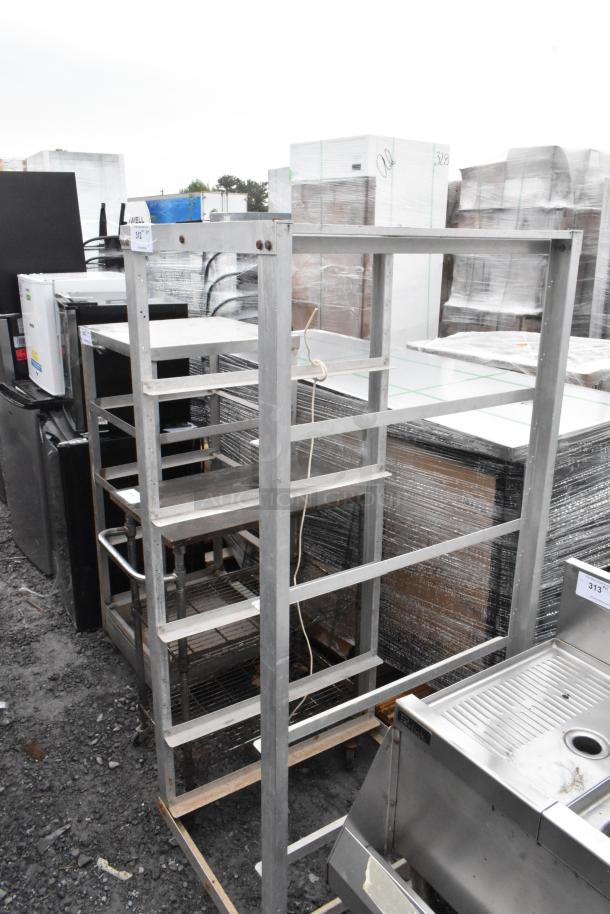 Metal commercial pan transport rack on casters, multi-tiered, sturdy construction, slight rust on some surfaces, tag marked "312".