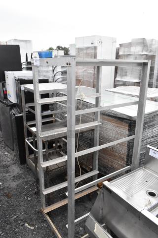 Metal commercial pan transport rack on casters, multi-tiered, sturdy construction, slight rust on some surfaces, tag marked "312".
