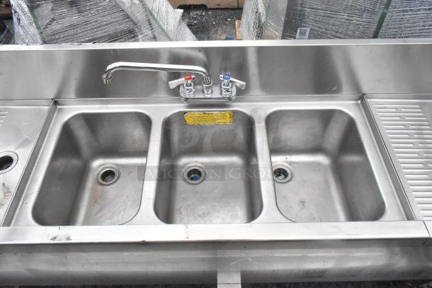 Perlick stainless steel 3 bay back bar sink with dual drainboards, Speedwell faucet, and handles. Features visible labels.