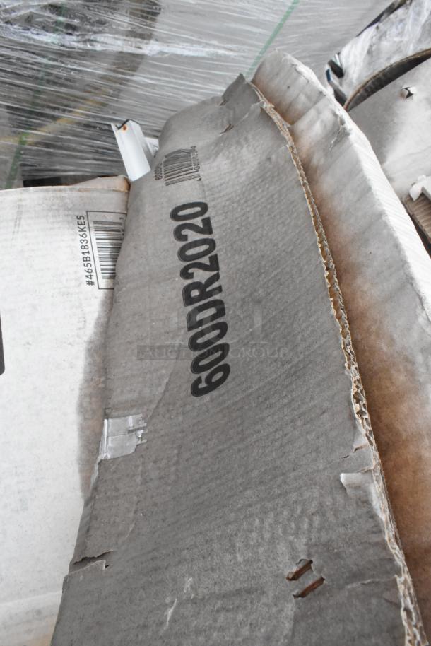 Cardboard box with "600DR2020" marked, containing a Regency drawer and Steelton shelf kit. Box shows signs of wear.