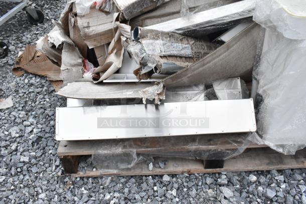 A pile of cardboard and plastic wraps, revealing a stainless steel 600DR2020 Regency drawer on a pallet, scratch and dent condition.