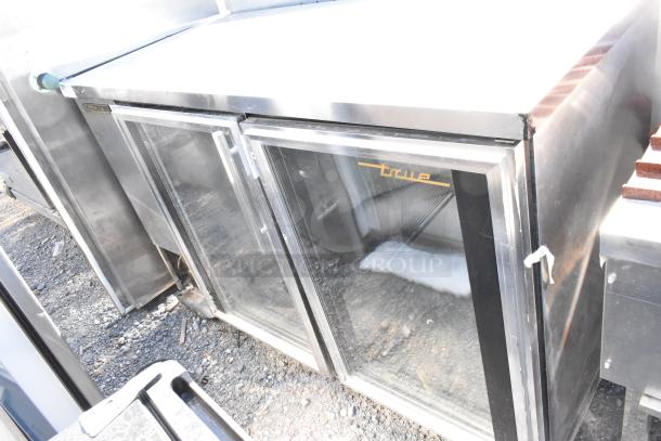 True TBB-2G-S stainless steel commercial back bar cooler with two glass doors. Model TBB-2G-S. Appears used.
