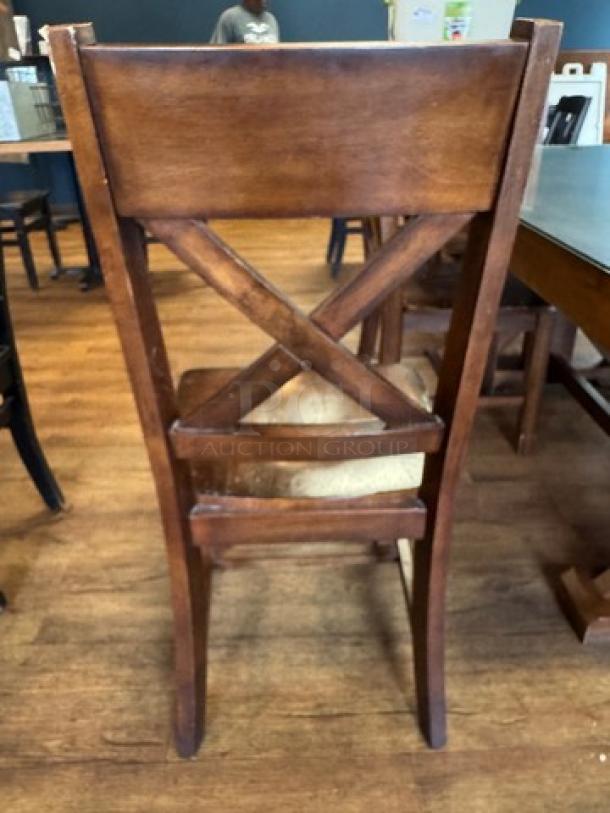 Set of 6 wooden dining chairs with X-back design, medium brown finish. Minimal wear, sturdy construction. Ideal for dining set.