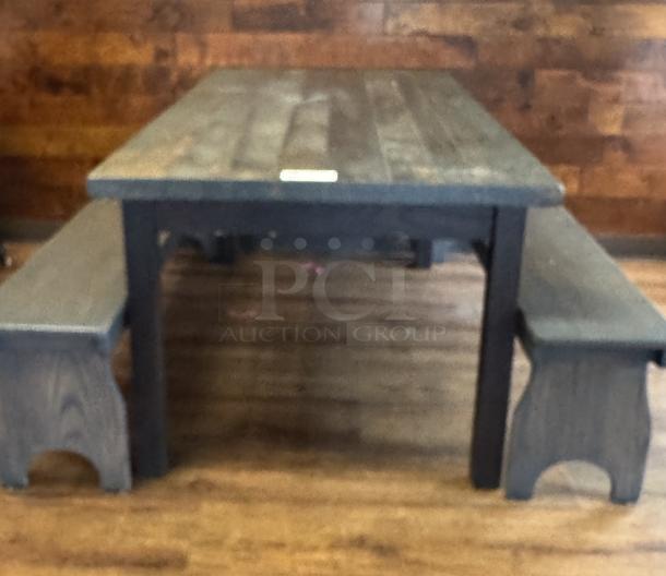 Amish made dining table with two matching bench seats. Wooden construction, rustic finish, in good condition. Unique craftsmanship.