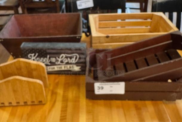 Assorted wooden boxes and baskets, varying finishes, including slatted and solid designs. One box features "Kneel for the Lord" text.