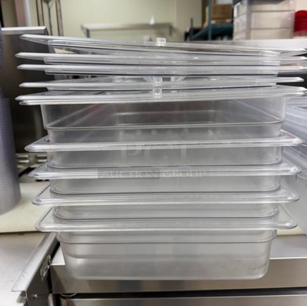 Stack of Cambro full-size clear containers with lids, in good condition, suitable for commercial use.