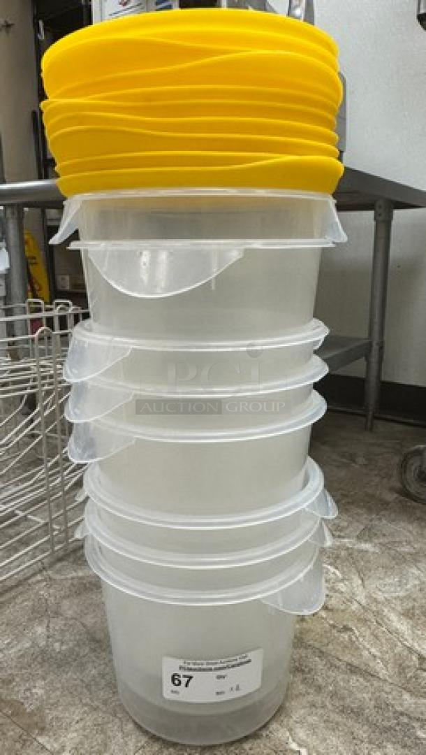 Stack of Rubbermaid plastic containers with yellow lids, set of 8. Clear bodies, used condition, label with "67" printed.