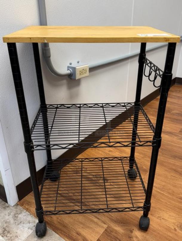 Rolling display/storage cart with a wooden top, black metal frame, two wire shelves, and casters. Features wine rack and sturdy build.