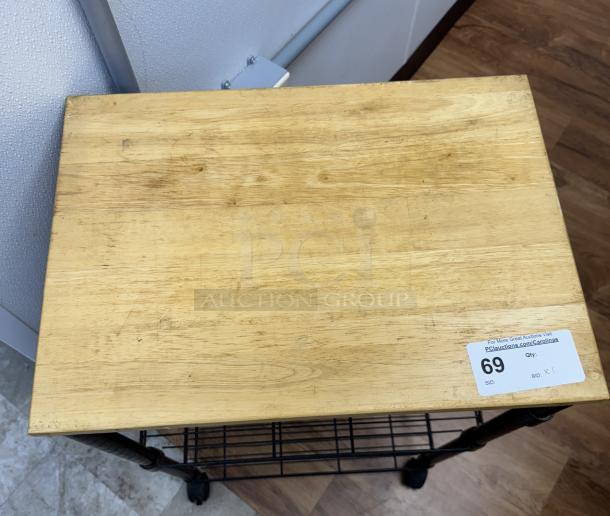 Wooden rolling display/storage cart with metal frame, wire shelves, and caster wheels. Features tag labeled "69." Slightly worn condition.