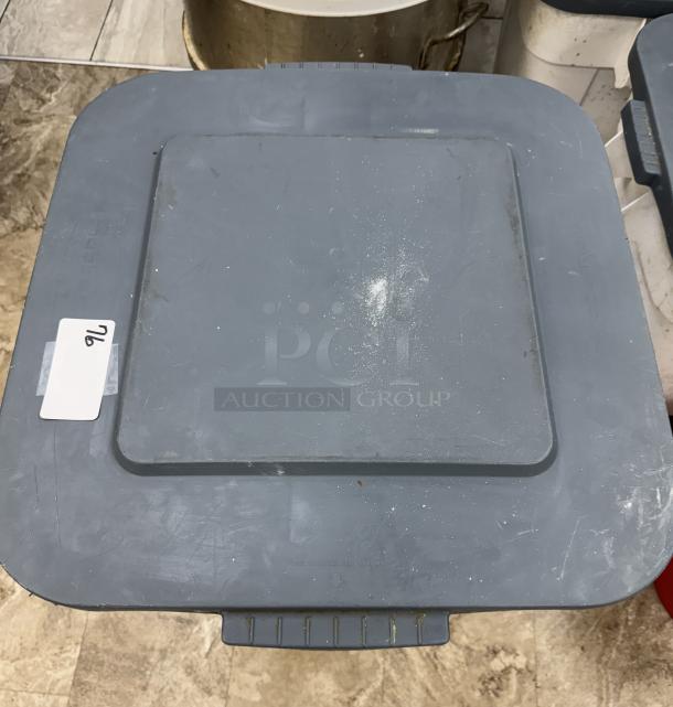 Rubbermaid 28 Gal. dry goods storage container on casters, gray, worn condition, top view with item tag "76".