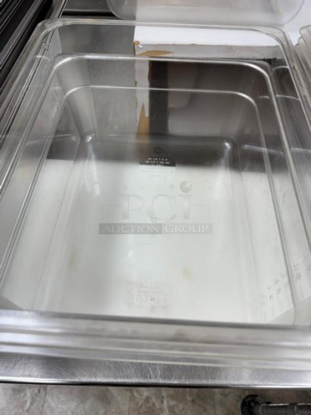 Cambro plastic containers with lids, clear, lightly used, stackable design. Includes visible volume markings. Set of 2.
