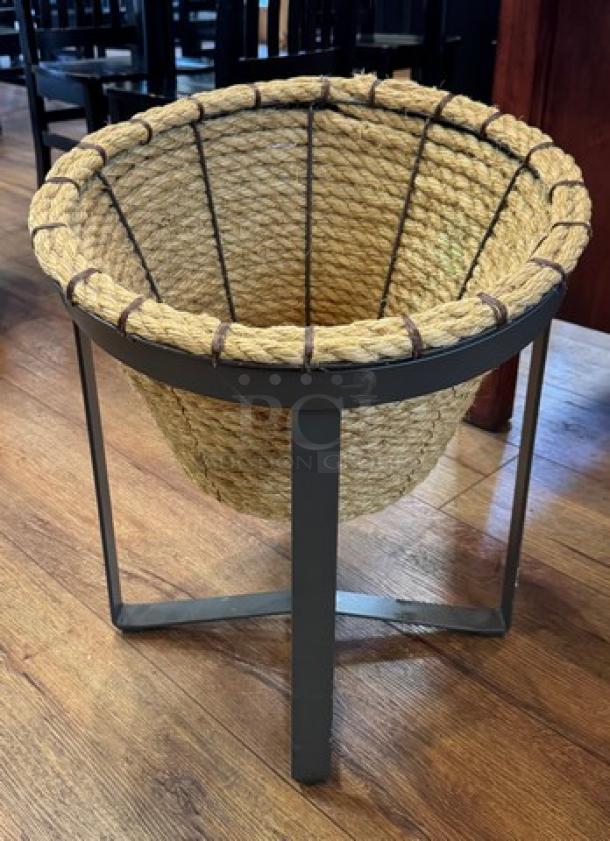 Metal and rope floor display with woven basket design; sturdy metal frame, excellent condition, ideal for decor or retail use.