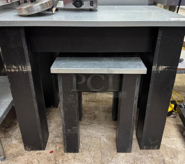 Metal top and wood tables, stacked. Large: 36x24x32 inches, small: 18x17x23 inches. Worn black finish.
