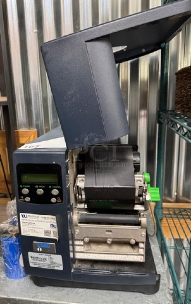 Westmark Labeling System with 5 label rolls; includes digital display and label feed. Slight wear; labels identify system specs.