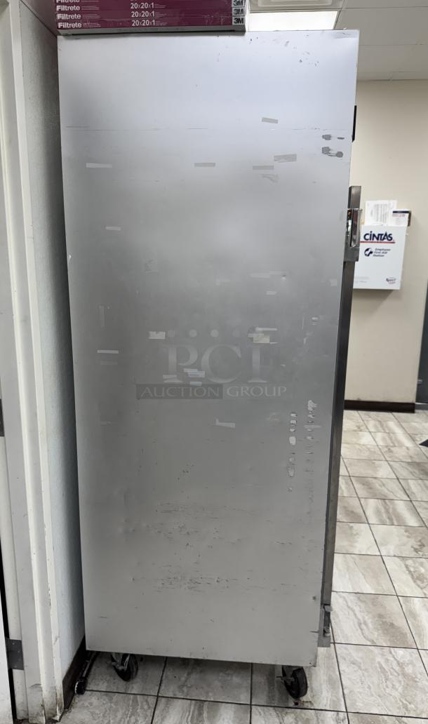 Traulsen G22010 2-door freezer, non-consistent operation, visible surface wear, standing on tiled floor.