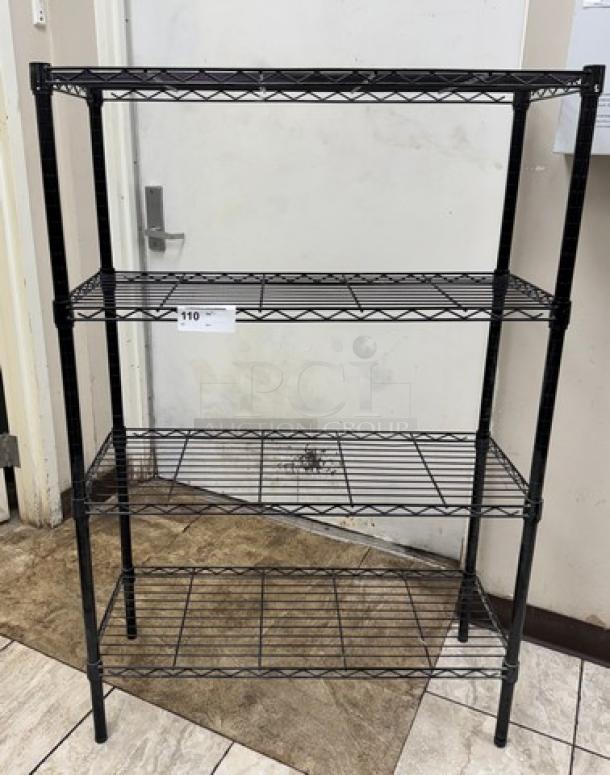 Black wire rack with 4 adjustable shelves. Sturdy metal construction. Price tag shows $110. Ideal for storage.
