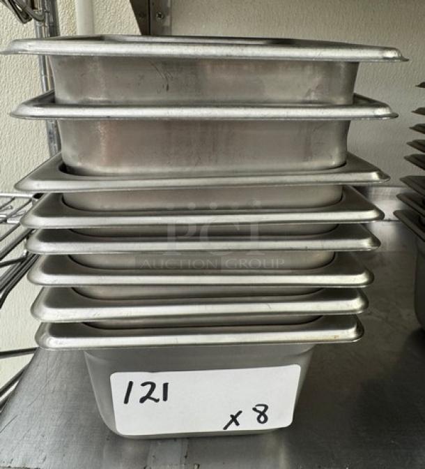 Stack of eight stainless steel 1/6 size pans, each 4 inches deep. Label indicating quantity: "121 x 8" visible.