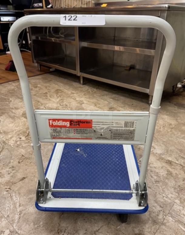 Folding platform cart with blue base, metal frame, and rolling wheels. Visible label reads "Folding Platform Cart." Excellent condition.