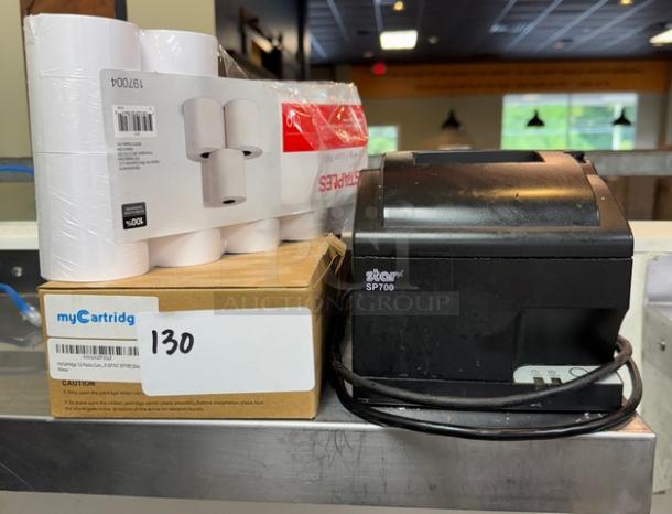 Star SP700 receipt printer with power cable, 4 ribbon cartridges, and 7 paper rolls; used condition.