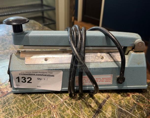 Upline 8" Impulse Sealer, Model H163, blue, used condition. Auction tag 132 visible, cord wrapped around base.