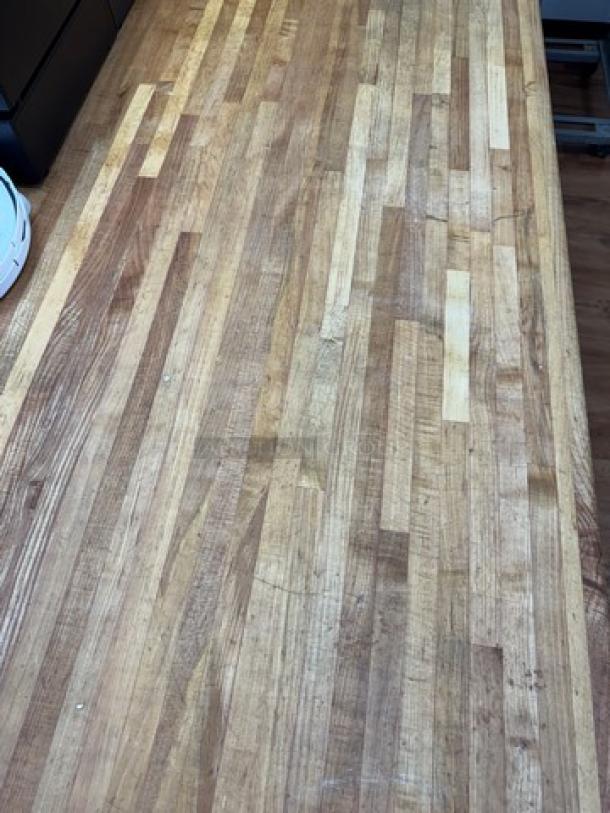 Large butcher block top table with galvanized metal legs. Features a durable wood surface, in good condition, ideal for kitchens or workshops.
