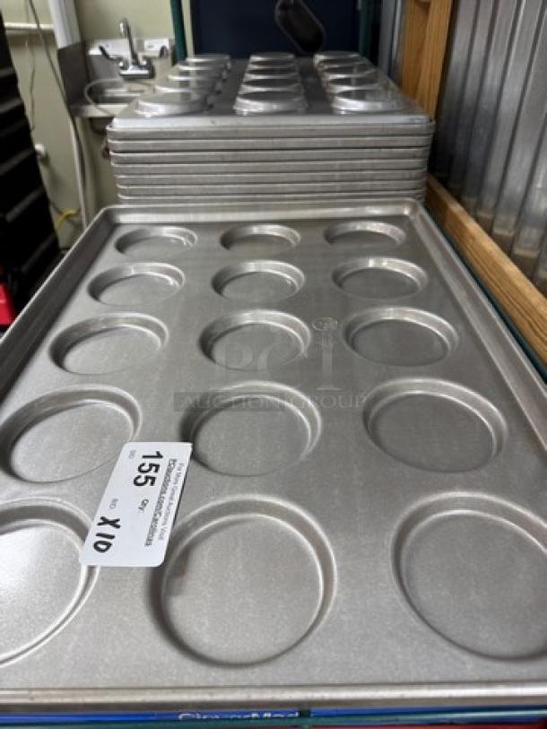 Chicago Metallic cookie sheets, set of 10, gently used, circular indentations, metallic finish, lot tag labeled "155 x/10."