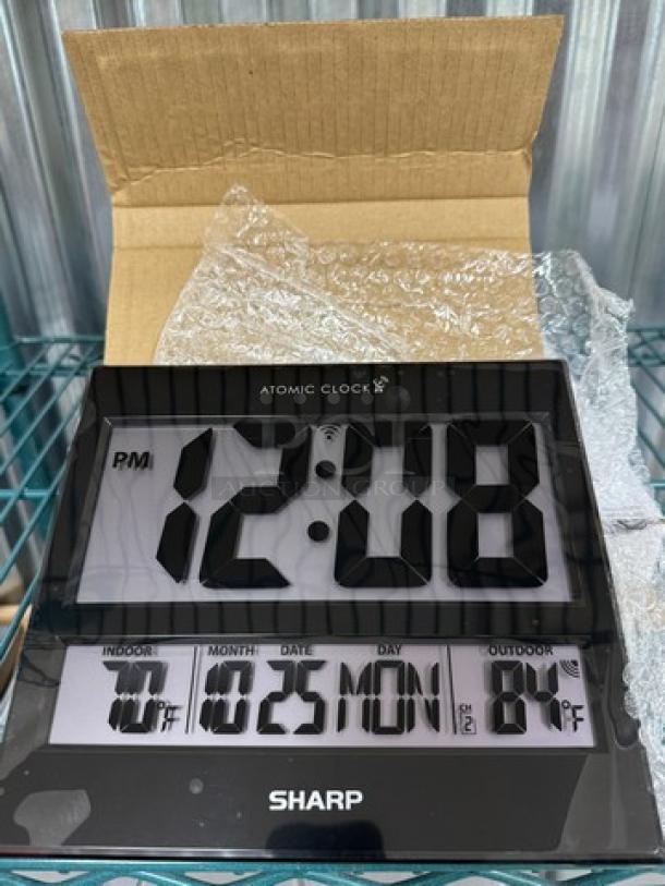 New in box Sharp Atomic Wall Clock with large digital display. Features indoor/outdoor temperature, date, and day indicators.