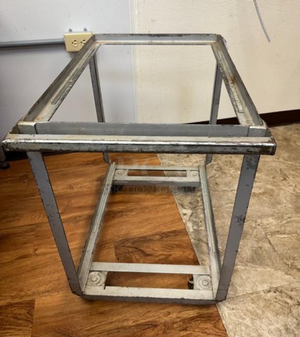 Rolling full-size sheet pan cart, metal frame, visible wear, sturdy design, suitable for commercial kitchen use.