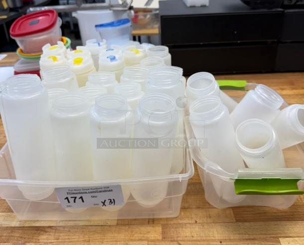 Assorted condiment dispensers in plastic bins, various colors and lid designs, total 31 pieces; visible tag reads “171 Qty X31.”