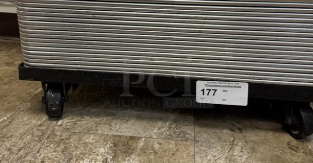 Full-size sheet pan rolling rack with sturdy wheels, visible tag marked "177." Ideal for kitchen and bakery use.