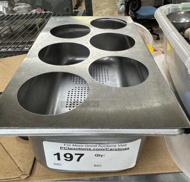 Stainless steel Tablecraft squeeze bottle holder with six round slots, perforated drainage, and auction label attached.