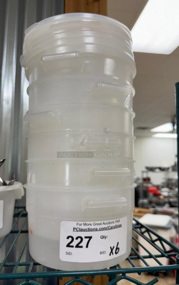 Stack of six 2 Qt. round containers with four lids, labeled "227 Qty: X6." Ideal for storage; clear plastic material.