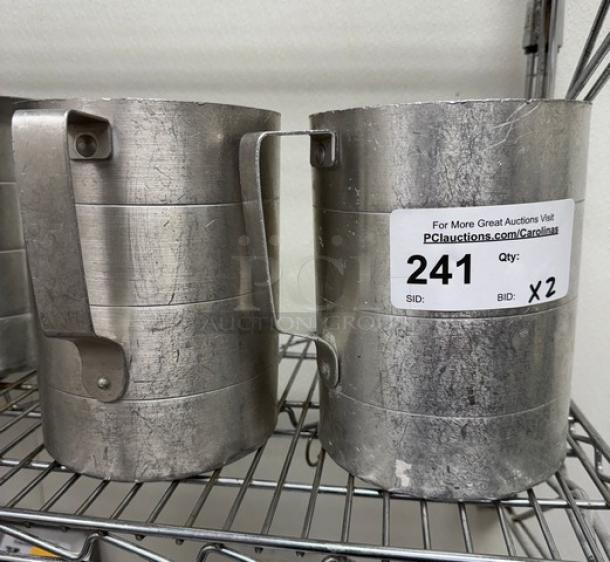 Metal 4 Qt. measuring cups, set of 2, with sturdy handles, visible wear. Auction label shows quantity and bid details.