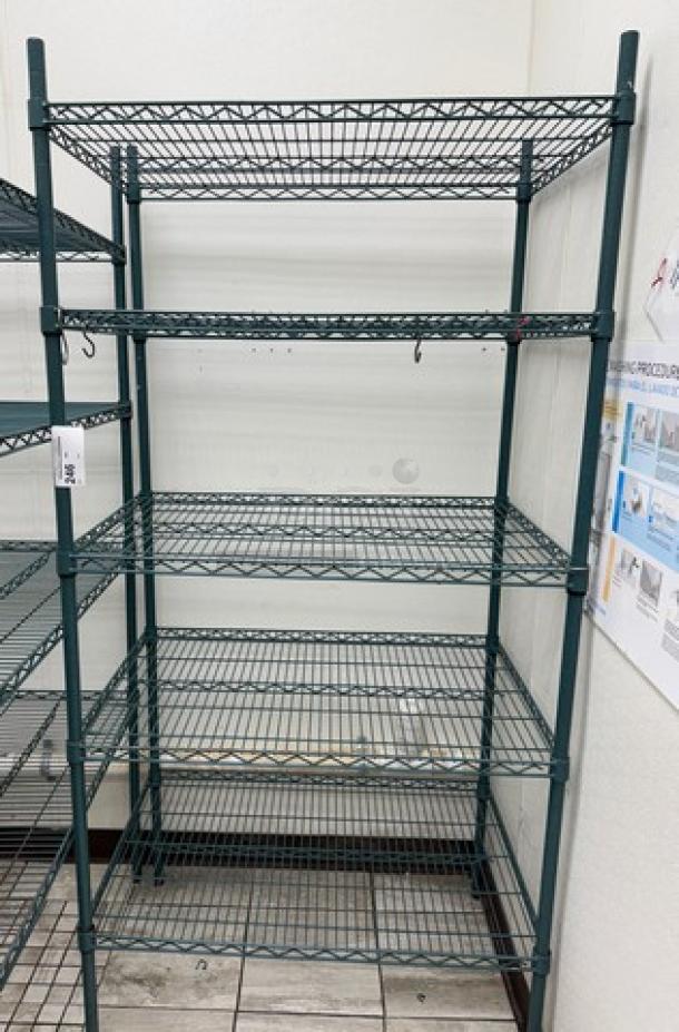 Wire rack with 5 adjustable shelves, metal construction, dark green finish, sturdy condition; ideal for storage and organization.