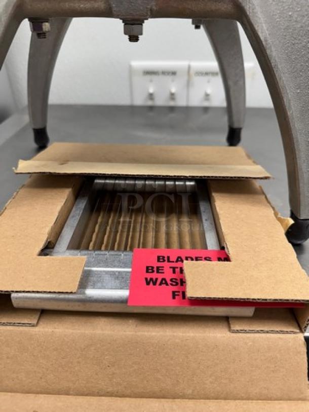 KEMCO Manual Dicer/Slicer, includes extra blades. Features stainless steel construction, boxed, with care label visible.