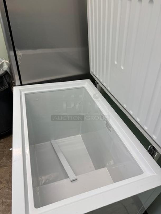 Atqsa chest freezer with open lid, showing clean interior. Tested and working. Sturdy build, white finish.