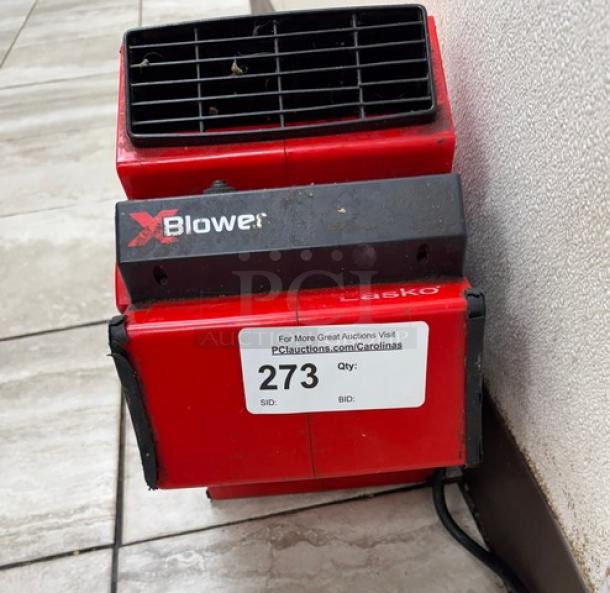 Red Lasko Blower Floor Fan, model XBlower, in used condition. Features front grille, markings visible, auction label 273.