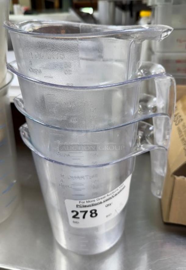 Three clear 2-quart measuring cups stacked, visible measurement markings, auction label with number 278.