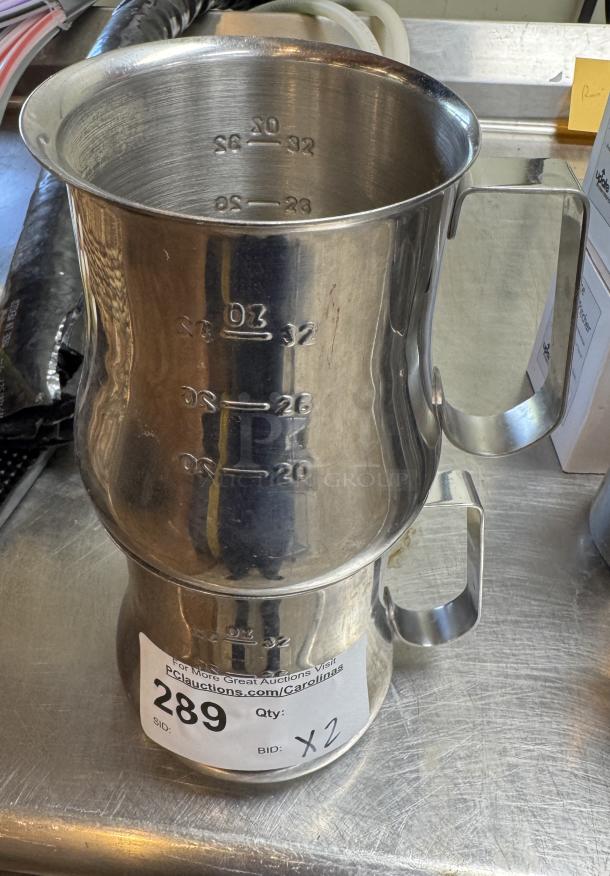 Two stainless steel 32 oz measuring cups with embossed measurements up to 32 oz. Auction label reads "Lot 289, Qty: 2."