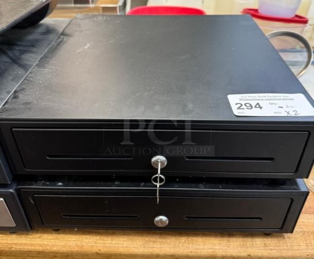 Black cash box with keys, square design, slight surface wear. Auction label indicates lot 294, quantity 2.