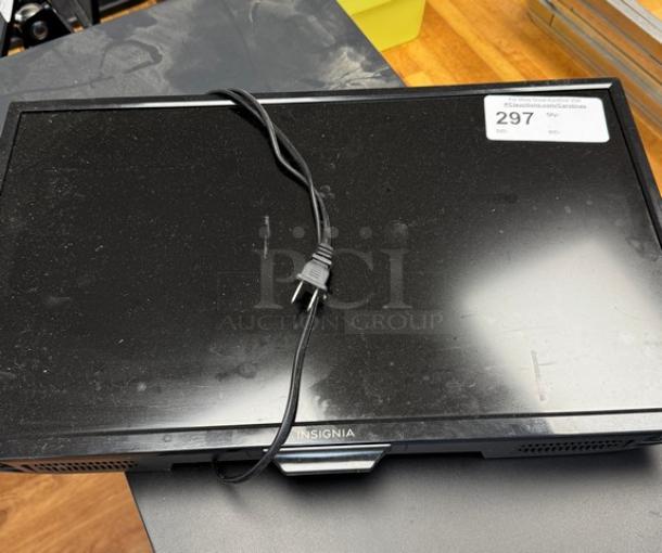 Insignia 25" monitor, black, with attached power cord, slight surface dust, auction tag visible on screen.