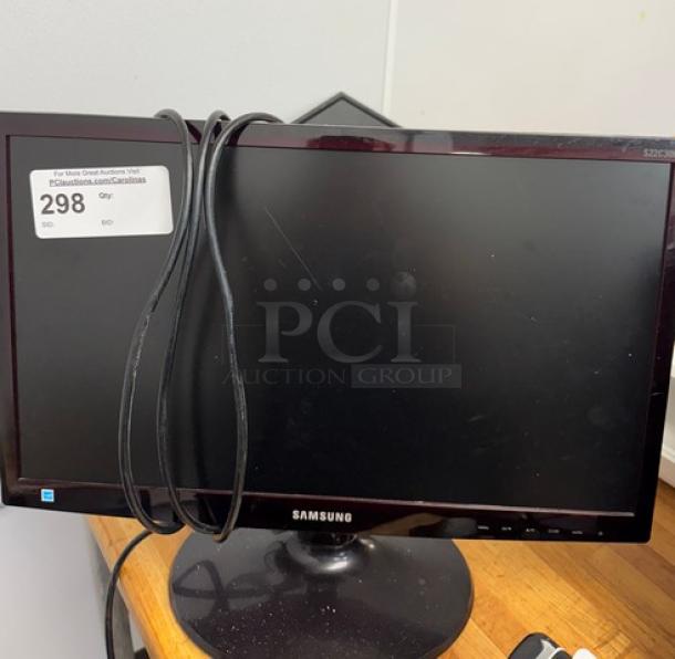 Samsung 23" monitor, model S23C350H, with visible cables. Tested and working, in good condition. Auction tag number 298.