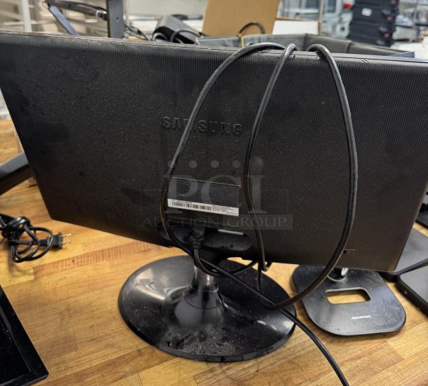 Samsung 23" monitor, tested and working, black finish, with cables attached, visible Samsung logo on the back, in used condition.