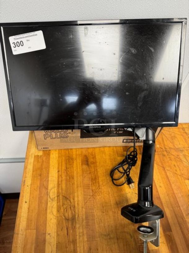 Insignia 25" monitor with table mount, tested and working. Slightly worn screen, model tag visible, cables included.