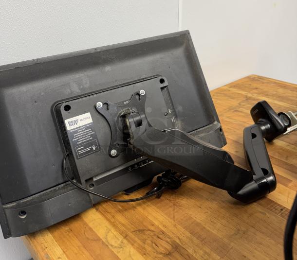 Insignia 25" monitor with table mount, tested and working. Black casing, rear view showing table mount attachment.