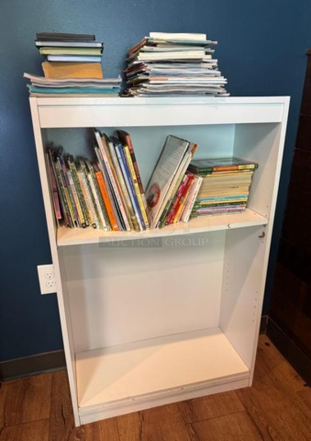 White bookcase with two shelves, filled with various books, in good condition. Books included with purchase.