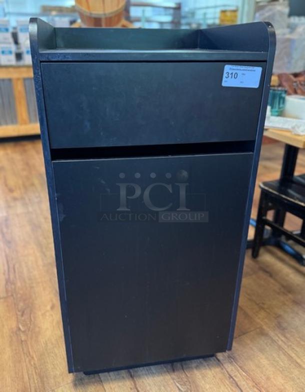 Black trash can bin, rectangular design, minor wear, auction tag 310 visible.